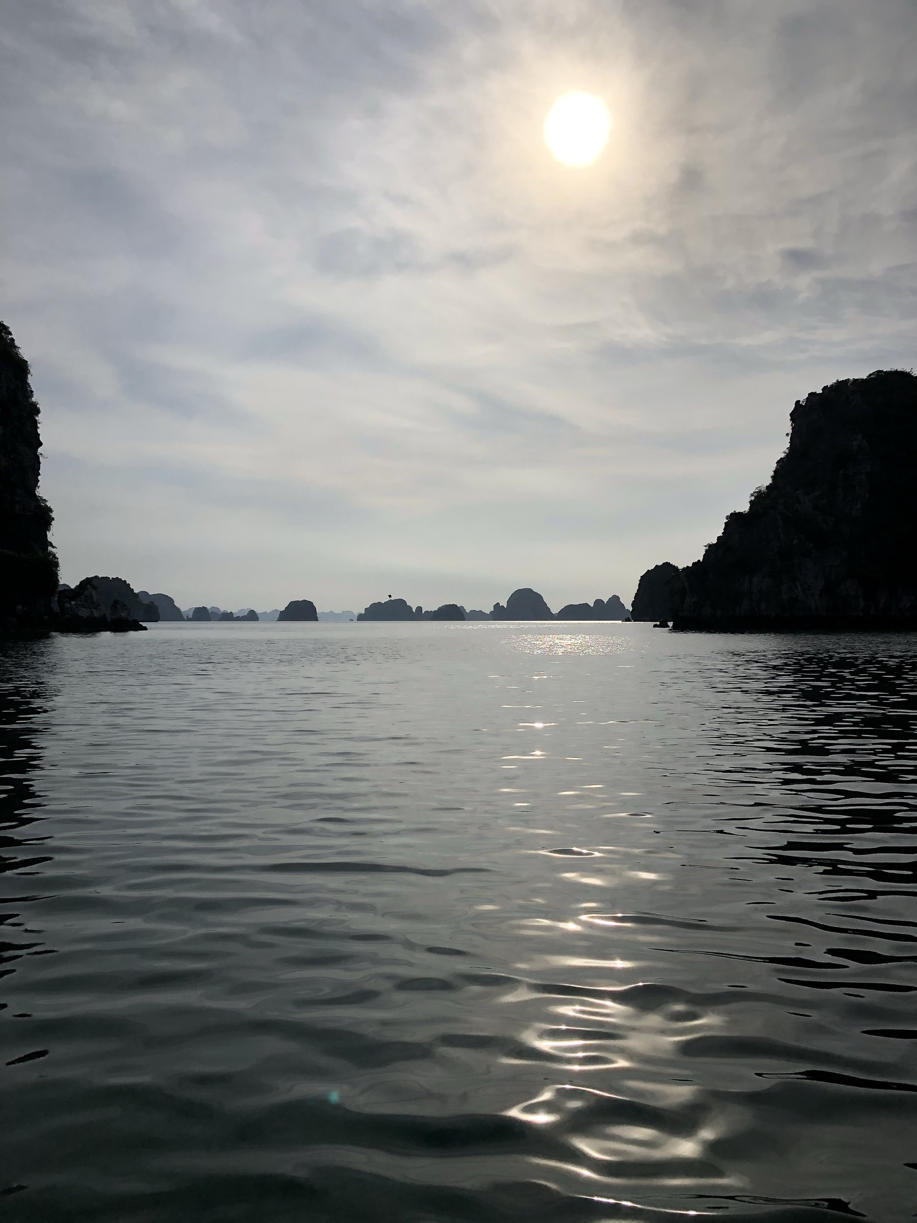 Hạ Long Bay, Việt Nam — limestone karsts silhouetted over calm water